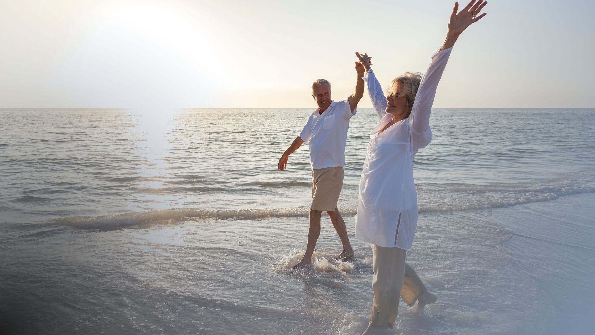 Couple celebrating on the beach at sunset
